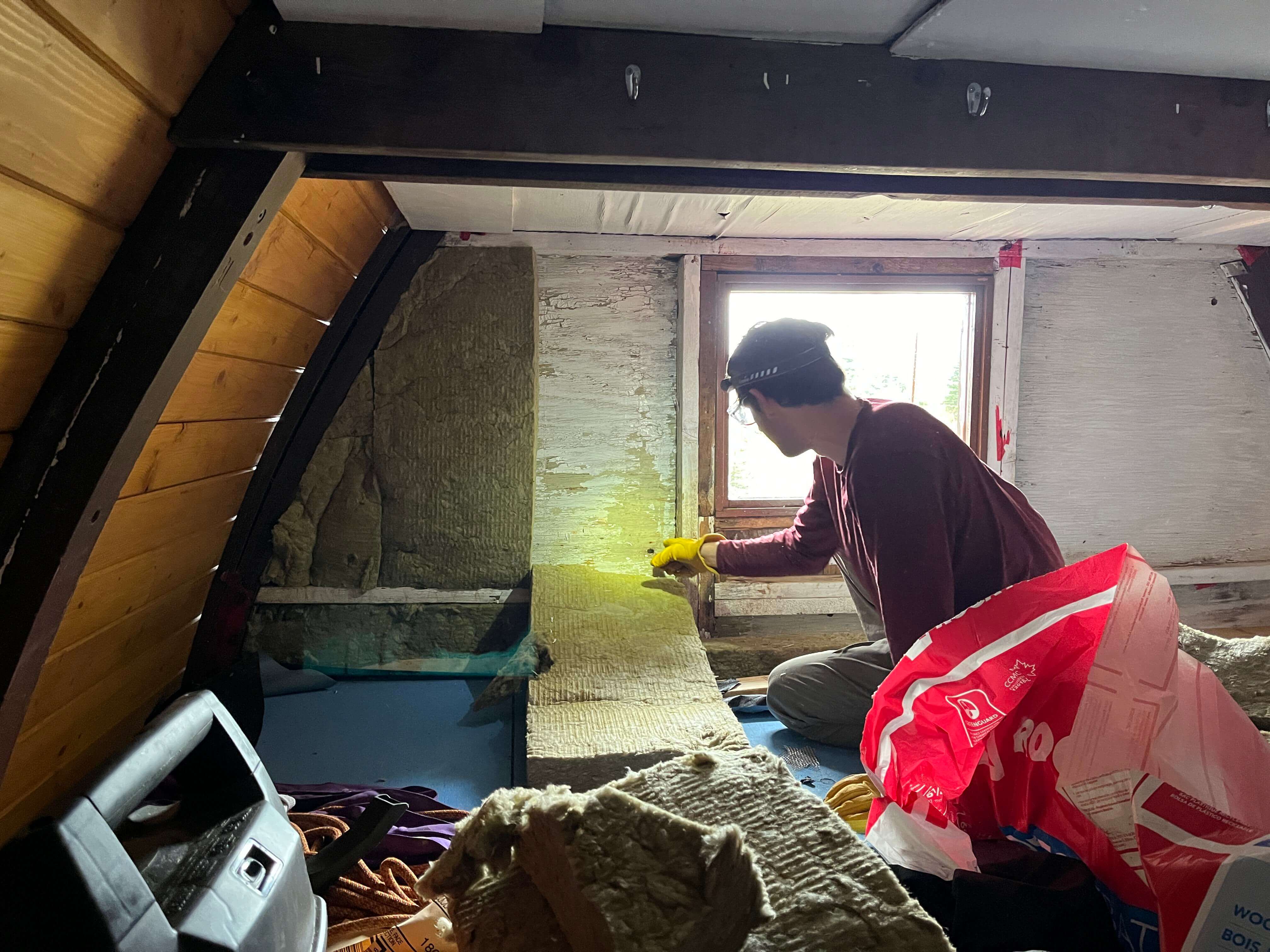 Jacob working on insulating the sleeping platform. PC: John Sherk